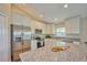 Spacious kitchen with stainless steel appliances and granite countertops at 7031 Red Grange Boulevard Ave, Indian Lake Estates, FL 33855
