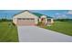 Single-story home with a green metal roof and attached garage at 7031 Red Grange Boulevard Ave, Indian Lake Estates, FL 33855