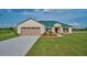 House exterior showcasing a green metal roof and landscaping at 7031 Red Grange Boulevard Ave, Indian Lake Estates, FL 33855