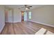 Large bedroom with wood-look flooring and access to bathroom at 7031 Red Grange Boulevard Ave, Indian Lake Estates, FL 33855