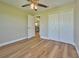 Bedroom with double closet and wood-look floors at 7031 Red Grange Boulevard Ave, Indian Lake Estates, FL 33855