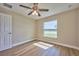 Bedroom with large window, ceiling fan and wood-look floors at 7031 Red Grange Boulevard Ave, Indian Lake Estates, FL 33855