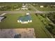 Single-Gathering home with green metal roof at 7031 Red Grange Boulevard Ave, Indian Lake Estates, FL 33855