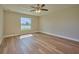 Well-lit bedroom featuring laminate flooring and a ceiling fan at 7031 Red Grange Boulevard Ave, Indian Lake Estates, FL 33855