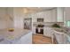 Updated kitchen featuring stainless steel appliances, granite counters, and white cabinetry at 7031 Red Grange Boulevard Ave, Indian Lake Estates, FL 33855