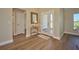 Bright entryway with wood-look floors and a small table at 7031 Red Grange Boulevard Ave, Indian Lake Estates, FL 33855