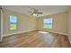 Bright bedroom with laminate flooring, ceiling fan, and large windows at 7031 Red Grange Boulevard Ave, Indian Lake Estates, FL 33855