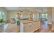 Open concept kitchen with granite island, stainless steel appliances, and white cabinets at 7031 Red Grange Boulevard Ave, Indian Lake Estates, FL 33855