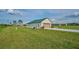 Single-car garage with metal roof and spacious driveway at 7031 Red Grange Boulevard Ave, Indian Lake Estates, FL 33855