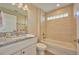 Clean bathroom with granite vanity and a bathtub at 7031 Red Grange Boulevard Ave, Indian Lake Estates, FL 33855