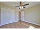Bedroom with double-door closet and wood-look floors at 7031 Red Grange Boulevard Ave, Indian Lake Estates, FL 33855