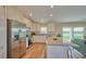 Modern kitchen with stainless steel appliances and granite countertops, open to the living area at 7031 Red Grange Boulevard Ave, Indian Lake Estates, FL 33855