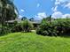 Front exterior view of a two-story home with lush landscaping and a green lawn at 1211 Cr 436, Lake Panasoffkee, FL 33538