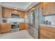 Modern kitchen with stainless steel appliances and light wood cabinets at 231 Riverside Dr # 709, Daytona Beach, FL 32117