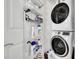 Well-organized laundry room with washer, dryer, and storage shelves at 231 Riverside Dr # 709, Daytona Beach, FL 32117