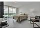 Bedroom with a queen bed, balcony access and marble floors at 231 Riverside Dr # 709, Daytona Beach, FL 32117