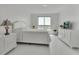 Bright bedroom with a queen-size bed, white dresser, and marble floors at 231 Riverside Dr # 709, Daytona Beach, FL 32117