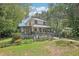 Two-story house with a blue door and a wooden deck at 3603 Cr 626N, Bushnell, FL 33513