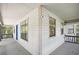 Inviting front porch with blue door and wooden railings at 3603 Cr 626N, Bushnell, FL 33513