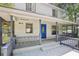 Charming front porch with blue door and wooden railings at 3603 Cr 626N, Bushnell, FL 33513