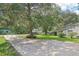 Landscaped yard with driveway and mature trees at 3603 Cr 626N, Bushnell, FL 33513