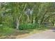 Landscaped front yard with mature trees and shrubs at 3603 Cr 626N, Bushnell, FL 33513
