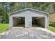 Spacious two-car garage with overhead doors and ample storage space at 3603 Cr 626N, Bushnell, FL 33513