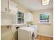 Laundry room with washer, dryer and built in cabinets at 3603 Cr 626N, Bushnell, FL 33513