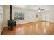 Living room with hardwood floors and wood burning stove at 3603 Cr 626N, Bushnell, FL 33513