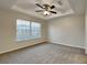 Bright bedroom with carpeted floor and large window at 2217 Betsy Ross Ln # A, St Cloud, FL 34769