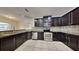Modern kitchen with dark cabinets, granite counters and stainless steel appliances at 2217 Betsy Ross Ln # A, St Cloud, FL 34769