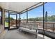 Cozy screened porch with a sofa and view of the water at 696 Caribbean Dr, Lakeland, FL 33803