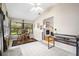 Sunroom with tiled floor, wooden furniture, and access to the backyard at 696 Caribbean Dr, Lakeland, FL 33803