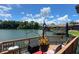 Deck with seating area overlooking a calm river under a bright sky at 696 Caribbean Dr, Lakeland, FL 33803