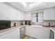 Kitchen with white cabinets, tile countertops, and modern appliances at 696 Caribbean Dr, Lakeland, FL 33803