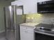Stainless steel appliances and white shaker cabinets feature in this updated kitchen at 10742 W Beach Pkwy, Lake Wales, FL 33898