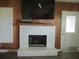 White brick fireplace with wood mantel and built-in shelving at 10742 W Beach Pkwy, Lake Wales, FL 33898