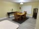 Dining room with wooden table, four chairs, and a display cabinet at 10742 W Beach Pkwy, Lake Wales, FL 33898
