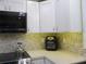 Modern kitchen corner with white cabinets and an air fryer at 10742 W Beach Pkwy, Lake Wales, FL 33898