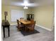 Dining room with wooden table, four chairs, and a display cabinet at 10742 W Beach Pkwy, Lake Wales, FL 33898