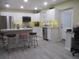 Open concept kitchen with island and stainless steel appliances at 10742 W Beach Pkwy, Lake Wales, FL 33898