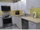 Modern kitchen with white cabinets and stainless steel appliances at 10742 W Beach Pkwy, Lake Wales, FL 33898