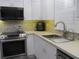 Modern kitchen with stainless steel appliances and white cabinets at 10742 W Beach Pkwy, Lake Wales, FL 33898