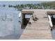 Wooden dock extending over calm water with ducks at 10742 W Beach Pkwy, Lake Wales, FL 33898