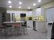 Modern kitchen featuring stainless steel appliances and an island with seating at 10742 W Beach Pkwy, Lake Wales, FL 33898
