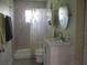 Updated bathroom with shower, vanity, and a large mirror at 10742 W Beach Pkwy, Lake Wales, FL 33898
