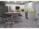 Open concept kitchen with island and four barstools at 10742 W Beach Pkwy, Lake Wales, FL 33898