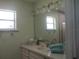 Bathroom with shower, vanity, and updated fixtures at 10742 W Beach Pkwy, Lake Wales, FL 33898