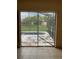 View of backyard pool through sliding glass doors at 417 Bay Leaf Dr, Kissimmee, FL 34759