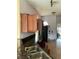 Kitchen with dark countertops and wood cabinets needing updating at 417 Bay Leaf Dr, Kissimmee, FL 34759